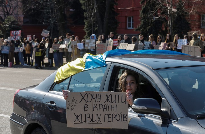 Un ucraniano sostiene un cartel que dice "¡Quiero vivir en el país de los héroes vivientes!" durante una manifestación en la que las autoridades se dirigieron a los familiares del alguacil ruso, en el centro de Kiev.  Foto EFE